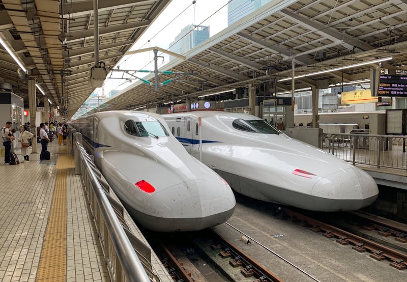 Two shinkansen bullet trains waiting at the platform at Tokyo Station